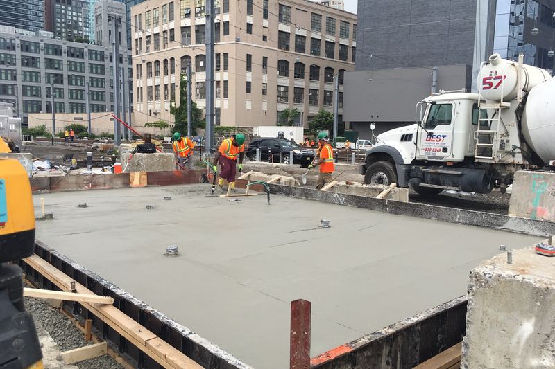 Finishing the poured concrete foundation for a future facility power substation. 08-06-2019